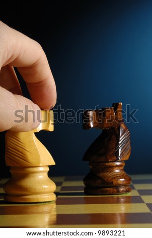 hand making a chess move with knight