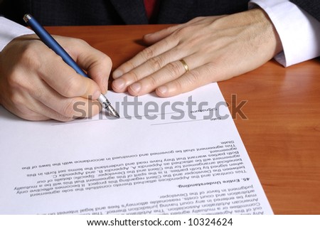 close up of a businessman signing a contract