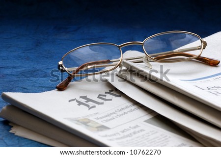 international newspapers with reading glasses
