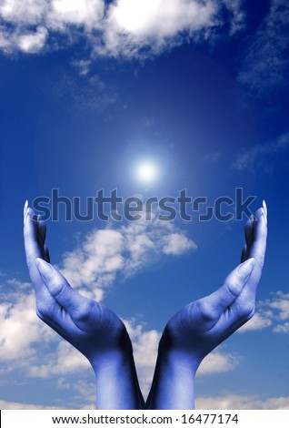 open female hands in front of a blue sky with a sun flare