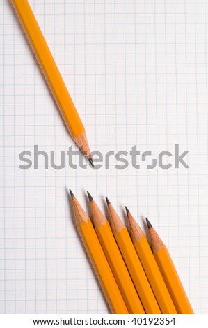 yellow drawing pencils on a white squared graph paper