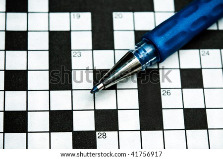 pen lying on a blank crossword to be filled