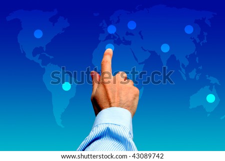 male hand touching a point on a world map, global choice concept