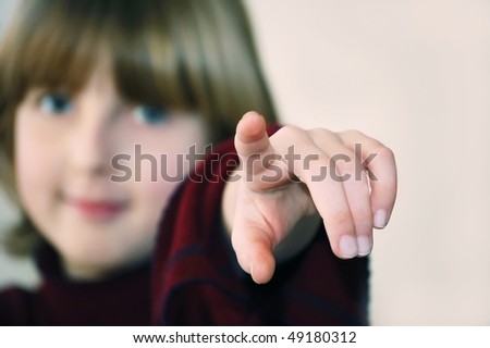 a teenager girl pointing her finger forward
