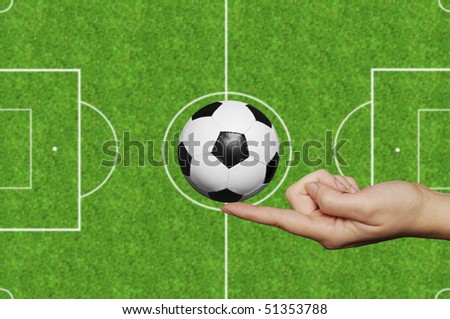 female hand holding a soccer ball on tip of finger