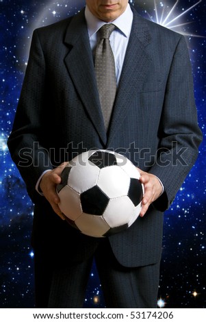 businessman holding a soccer ball , concept for sport as business
