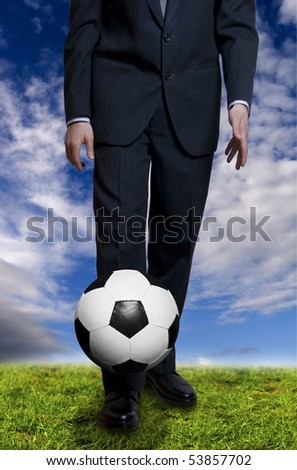man in suit playing with a soccer ball, concept for sport and business