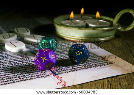 esoteric runes, astrological dice, three candles over old mystical text