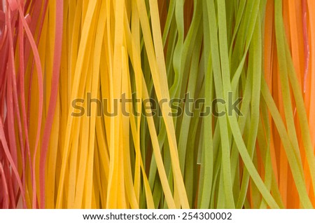 Multicolored raw long italian noodles