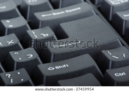 Black computer keyboard close-up. Focused on \'Enter\' key