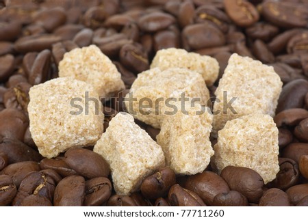 Few pieces of brown sugar over the coffee beans
