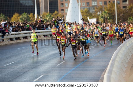 VALENCIA - NOVEMBER 18: Kipiyego (number 16) leads the group with other runners at first meters of the marathon, in Valencias marathon on November 18, 2012 in Valencia, Spain