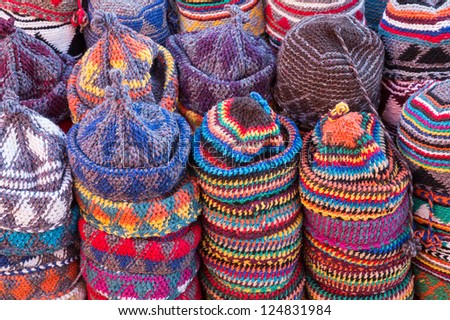 background of colorful wool caps for sale in the market