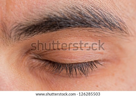 Caucasian man closed left eye and eyebrow