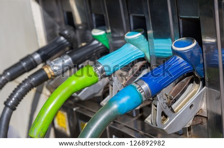 side view of many gas pump nozzles with shallow depth of field