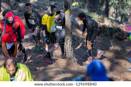 CASTELLON - FEBRUARY 24: Enrique Hernandez Ponce (number 187) takes a rest during his participation in XV Edition of Espadan mountain marathon on February 24, 2013 in Castellon, Spain