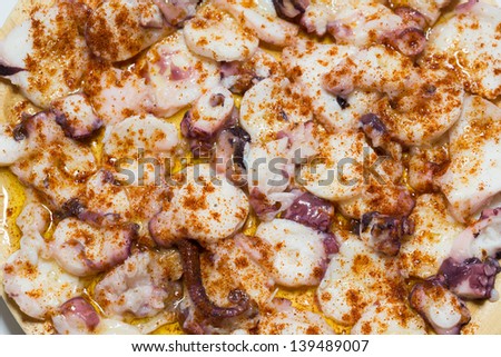 Top view of cooked octopus slices dressed with paprika