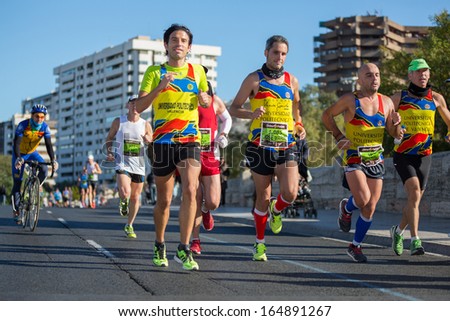 VALENCIA - NOVEMBER 17: Jose Maria Solaz Quer (number 1085) leads his UPV Team group during his participation in Valencias marathon on November 17, 2013 in Valencia, Spain