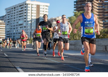VALENCIA - NOVEMBER 17: Jose Baixauli Martinez (number 339) leads his group during his participation in Valencias marathon on November 17, 2013 in Valencia, Spain