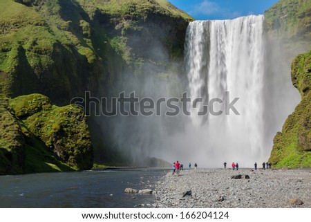 skogafoss waterfall and tourists (blurred faces) on the South of Iceland near the town Skogar