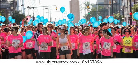 VALENCIA - APRIL 6: unidentified group of happy runners wait for the start of women race against cancer on April 6, 2014 in Valencia, Spain