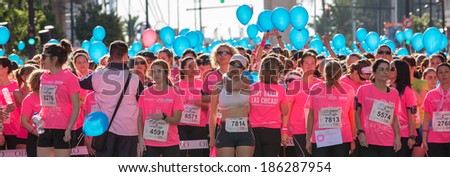 VALENCIA - APRIL 6: unidentified group of happy runners wait for the start of women race against cancer on April 6, 2014 in Valencia, Spain