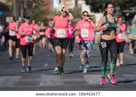 VALENCIA - APRIL 6: unidentified group of happy runners participate in women race against cancer on April 6, 2014 in Valencia, Spain