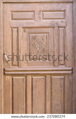Religious decorated old wooden door, brown painted with chalice