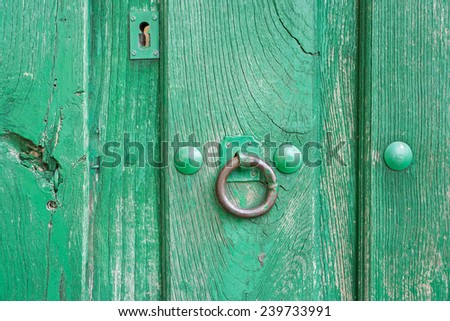 Closeup of vintage run-down wooden door (green painted)