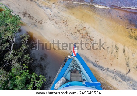 Big boat runs aground in sand beach in Rio Negro, Amazon, Brazil