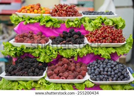 Detailed view of berries on trays in the market, shallow depth of field
