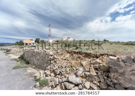 Wide angle view of defensive entrance to abandoned military zone with ruined wall