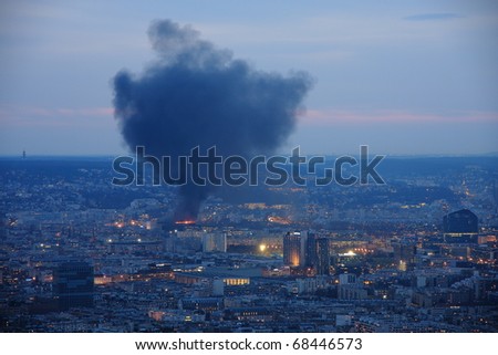 PARIS - MARCH 17: Fire at night on March 17, 2010 in Paris. Fire started Wednesday night in a former incinerator near the docks of Issy-les-Moulineaux, causing a cloud of smoke
