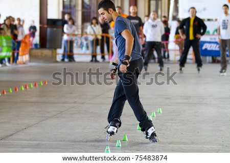 VALENCIA, SPAIN - APRIL 16: Side view of amateur Inline Skater doing acrobatics with cones in the roller skate exhibition day celebrated each year on April 16, 2011 in Valencia, Spain