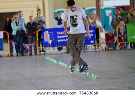 VALENCIA, SPAIN - APRIL 16: Front view of amateur Inline Skater doing acrobatics with cones in the roller skate exhibition day celebrated each year on April 16, 2011 in Valencia, Spain