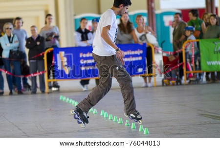 VALENCIA, SPAIN - APRIL 16: Rear view of amateur Inline Skater doing acrobatics with cones in the roller skate exhibition day celebrated each year on April 16, 2011 in Valencia, Spain
