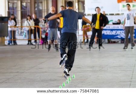 VALENCIA, SPAIN - APRIL 16: Rear view of amateur Inline Skater doing acrobatics with cones in the roller skate exhibition day celebrated each year on April 16, 2011 in Valencia, Spain