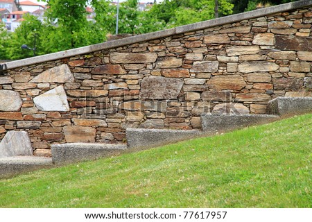 side view of stairs and stone wall