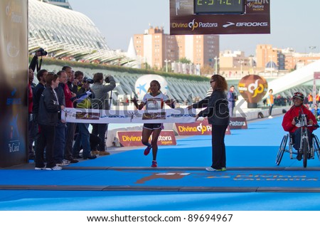 VALENCIA - NOVEMBER 27: Abo (number 72) winning the womens marathon race at finish line in Valencias Marathon on November 27, 2011 in Valencia, Spain