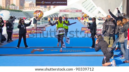 VALENCIA - NOVEMBER 27: kosgei (number 8) winning the mens marathon race at finish line in Valencias Marathon on November 27, 2011 in Valencia, Spain
