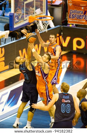 VALENCIA, SPAIN - JANUARY 28: Several players fighting under the basket during the ACB league match between Valencia Basket  and Asefa Estudiantes, 85-71, on January 28, 2012, in Valencia, Spain