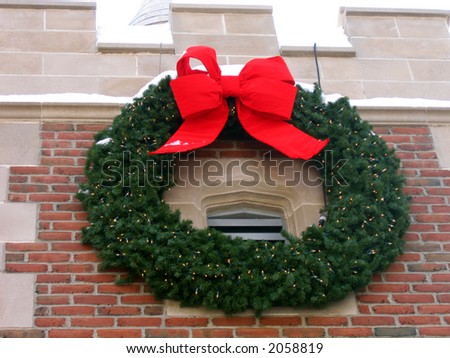 A Large Green Wreath With a Red Bow