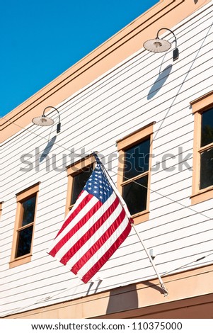 American flag attached to a small town building in the USA