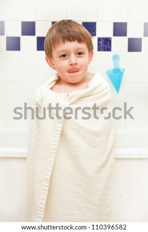 Young boy at bath time in a towel