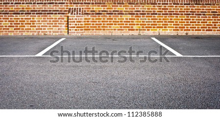 An empty car parking space in a modern parking lot