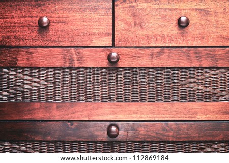 Close up of a chest of drawers made from mahogany wood