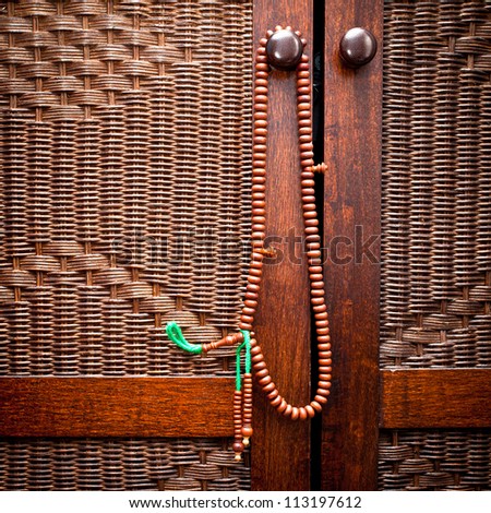 Wooden islamic prayer beads hanging on a door handle