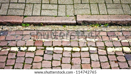 An old cobbled road and pavement in a UK town