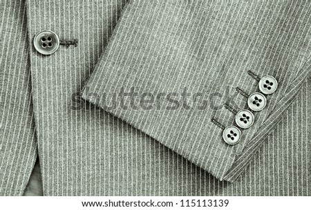 Close up of sleeve and center of a pin stripe suit in black and white