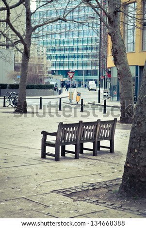 A wooden bench in an urban public space